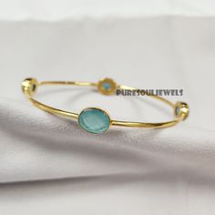 Aqua Chalcedony Bangle, 925 Silver Gold Plated Bangle, Gemstone Bangle, Friendship Bangle, Vintage Bangle, Bangle Bracelet, Designer Bangle Handmade item Gemstone: Aqua Chalcedony Materials: 925 Sterling Silver Finish: Gold Theme- Love & Friendship Style- Boho & Hippie Bangle Size-2.8X2.7 Inches Approx. Ready To Ship You can also have a look on our other amazing similar products here- >Blue Topaz Bangle- https://www.etsy.com/in-en/listing/1248466752/natural-blue-topaz-bangle-925-silver?click_key=4bc8f46c621d72ab25ab2e2efeeca74fecb3f791%3A1248466752&click_sum=1a79a935&ref=shop_home_active_20&pro=1&frs=1 >White Moonstone Bangle- https://www.etsy.com/in-en/listing/1262386807/white-moonstone-bangle-women-bangle-925?click_key=4d9f7b1ac7ee38f5c2b7fde576cac044956dc92b%3A1262386807&click_sum=eaa1a Gold Sterling Silver Bracelet With Gemstones, Adjustable Round Cuff Bracelet Fine Jewelry, Fine Jewelry Bracelets With Stones, Adjustable Fine Jewelry Bracelets With Stones, Adjustable Oval Fine Jewelry Bracelet, Elegant Adjustable Bangle With Stones, Round Crystal Bracelet With Stones, Sterling Silver Bangle Bracelet With Natural Stones, Adjustable Oval Bracelets With Stones