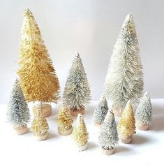 small christmas trees are lined up on a table