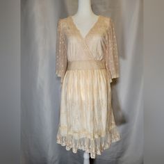 This New With Tags Dress Is In Overall Good Condition. Unworn. The Only Flaw To Note Is One Miniscule Dark Spot On The Bust. See Last Picture. Very Feminine Vintage Aesthetic. Beautiful Soft Peach Color. Lined With A Floral Lace Overlay. Fit And Flare, Flowy, With A Ruffle Hem.Hem. It Has A Crochet Detail Deep V-Neck And 1/2 Lace Bell Sleeves. It Has A Hidden Side Zipper Closure. Please See Pictures For Measurements To Ensure A Good Fit. It Is A Us Size 8, Neck Tag Has Uk Size 12 On It. Flowy V-neck Lace Dress For Spring, Beige V-neck Feminine Lace Dress, Bohemian Apricot V-neck Dress, Apricot Bohemian V-neck Dress, Peach Lace Trim Dress For Spring, Peach Lace Trim Dress For Summer, Beige V-neck Lace Dress For Spring, Apricot Lace Trim Dress For Spring, Spring Apricot Dress With Lace Trim