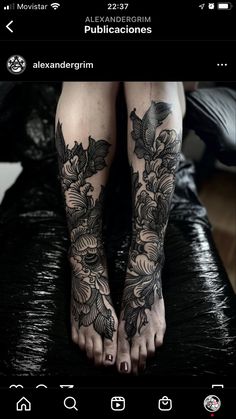 a woman's feet with tattoos on them and flowers in the middle of her legs