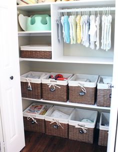 an organized closet with baskets and clothes