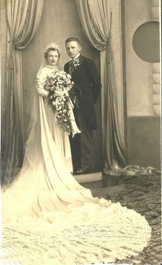 an old black and white photo of a man and woman posing for a wedding portrait