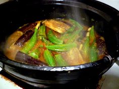 a pot filled with vegetables on top of a stove