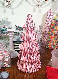 candy cane christmas tree sitting on top of a wooden table