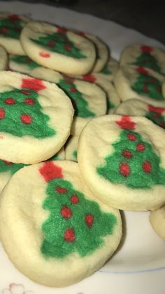 cookies decorated with green and red icing on a plate