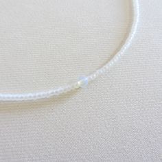 Moonstone beaded necklace, White seed bead necklace, Waterproof necklace, Tiny simple choker, Stainless steel necklace There are two clasp options, one is a stainless steel clasp and chain, the second option the clasp and chain are made of brass with 14k gold plating so the necklace will not lose its look over time! Choker is 13 inches with a 2 inches adjustable extender chain. 15 inches full length. The necklace is made with 10/0 size Czech seed beads. Measure the length of your neck with a measuring tape or you can use any thread, rope, or cable for telephone and after apply the measurements to a regular ruler. Minimalist White Choker For Everyday, Minimalist White Everyday Choker, Everyday Minimalist White Choker, Delicate Adjustable Everyday Choker, Adjustable Single Strand Crystal Choker Necklace, Adjustable Single Strand Crystal Choker, Minimalist Single Strand Beaded Necklace, White Minimalist Beaded Gemstone Necklace, Minimalist White Gemstone Beaded Necklaces