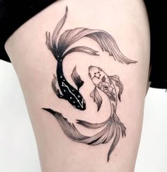 a woman's thigh with a fish tattoo on it