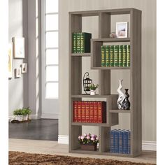 a bookshelf with many different types of books on it in a living room