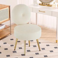 a white chair sitting on top of a rug in front of a desk with a mirror