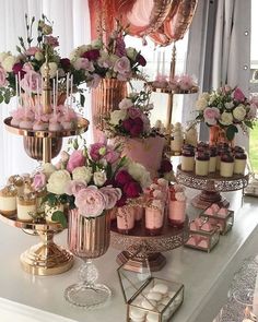 a table topped with lots of cakes and cupcakes