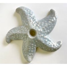 a ceramic starfish decoration on a white table