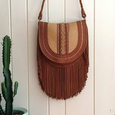 Surya Macramé Fringe Bag Caramel Leather Satchel Shoulder Bag, Caramel Leather Crossbody Shoulder Bag, Bohemian Saddle Shoulder Bag For Everyday Use, Artisan Natural Leather Bags, Bohemian Leather Bags In Natural Color, Bohemian Brown Satchel With Leather Lining, Artisan Shoulder Bag With Fringe For Everyday Use, Bohemian Saddle Bag For Everyday, Bohemian Saddle Bag For Everyday Use