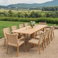 a wooden table and chairs in the middle of a field