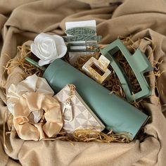 an assortment of women's handbags and purses in a box on a bed