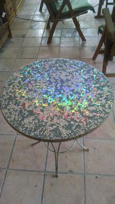 a table that is on the ground with chairs in the background