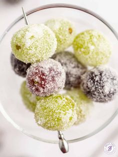 small desserts sit in a glass bowl on a table