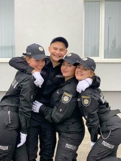 a group of people in uniform posing for a photo together with their arms around each other