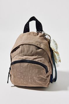 a small backpack with a bird on the handle and strap around it's neck