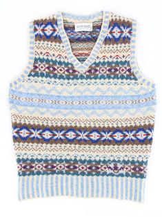 "This sleeveless sweater vest is made of soft Shetland wool, woven in a Fairisle pattern that gives it a classic 40s look. Hand-produced in Scotland using quality, natural yarns spun that keep you truly warm, by ERIBÉ, an established knitwear design house and manufacturer that has been in operation for 33 years. The Nordic blue tank top features rows of Fairisle patterning and stripes across the V-shaped neck, as well as on the bottom hem. This colourway is a mix of white, green, red and blue colours. A truly stand-out addition to a vintage enthusiast's wardrobe, these knits keep you warm and add a dash of colour to any retro outfit. 100% soft-feel Shetland wool, made using knowledge handed down from one generation to the next to create a sustainable product which looks and feels great whi Vintage Uniform, Vintage Fair Isle, Nordic Vintage, Nordic Blue, 1950s Retro, Sleeveless Sweater Vest, Vintage Tank Top, Vintage Tank, 50s Style