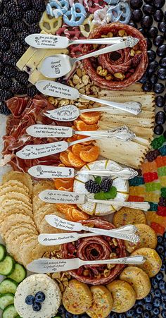 many different types of food are arranged on a platter with fruit and crackers