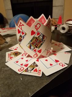 several playing cards are arranged on a table in front of a fire place and fireplace