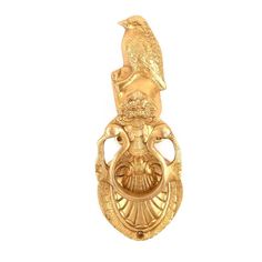 an ornate gold door handle with a bird on it