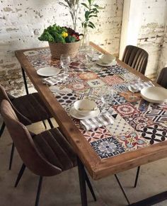 a wooden table topped with plates and cups