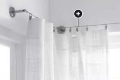 the curtain is hanging in front of a window with white curtains and lights on it