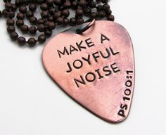 a necklace with a heart shaped pendant that says make a joyful noise