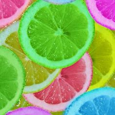 a bunch of lemons and lime slices are arranged in the shape of a rainbow