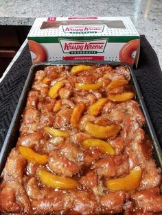 a box of krispy kreme peach cobbler sitting on top of a counter