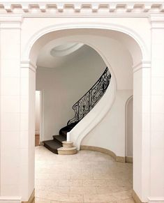 an arched staircase leading up to the second floor