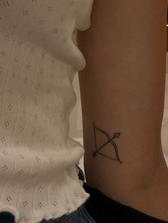 a woman's arm with a tattoo on it and an arrow in the middle