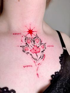 a woman's chest with flowers and stars tattooed on the top of her chest