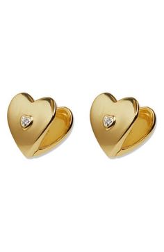 Accessorize in style with these sterling silver earrings featured in a sweet heart shape centered by a cubic zirconia and plated in gleaming 18-karat gold. 1/2" drop Omega-clip closure Sterling silver/18k-gold plate/cubic zirconia Imported Elegant Sterling Silver Heart Huggie Earrings, Gold Heart Earrings With Diamond Accents For Formal Events, Gold Heart Earrings With Diamond Accents For Formal Occasions, Elegant Gold Heart Earrings With Diamond Accents, Formal Gold Heart Earrings With Diamond Accents, Elegant Sterling Silver Huggie Earrings With Heart Charm, Gold Plated Heart Earrings For Anniversary, Gold Plated Heart Huggie Earrings For Anniversary, Elegant Huggie Earrings With Heart Charm For Anniversary