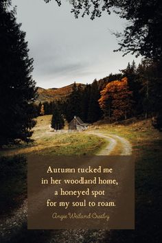 a dirt road in the middle of a forest with a quote on it that reads autumn tucked me in her woodland home, a honeyed spot for my soul to roam