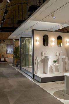 a white bathroom with three sinks and two mirrors on the wall next to each other