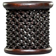 a wooden stool with an intricate design on it