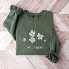 Michigan State Flower Sweatshirt, Embroidered Michigan Crewneck Sweater, Apple Blossom Flower Shirt, Embroidered Michigan Sweatshirt This embroidered Michigan crewneck sweatshirt is everything. Perfect to show your love for the state! Please let me know if you would like extended sizing (3X-5X), I have certain color and size options available! ✨ 50% cotton, 50% polyester ✨ Pre-shrunk ✨ Classic fit Care: Machine wash: cold (max 40C or 105F) Tumble dry: low Do not iron directly on the design REFUN Michigan State Flower, Apple Blossom Flower, Michigan Sweatshirt, Flower Sweatshirt, Flower Shirt, Apple Blossom, Michigan State, Blossom Flower, Crewneck Sweater