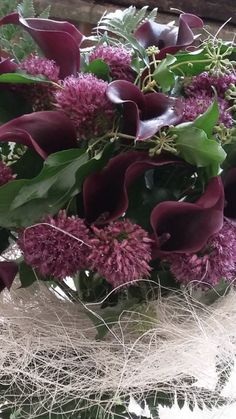 a vase filled with lots of purple flowers