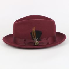 The Ayden Fedora offers a timeless and sophisticated style, blending vintage charm and modern appeal. Its intricate design is carefully crafted with precision and care, complete with a Matching Satin Grosgrain Band and a hand-crafted feather bundle.   Brim: 2 “(Snap Brim) Crown Height: 4.8 inches (Center Dent) Shape: Fedora, Crushable Material: 100% Fine Australian Wool Band: Satin Grosgrain 1.5 Interior: Satin Lining with Cotton Moister Wicking Sweat Band Removable SL Logo Pin Complementary Hat Sl Logo, Bow Tie Pants, Burgundy Hat, Crystal Dress, Crown Heights, Hat Boxes, Pin Logo, Hat Box, Black Shirt Dress