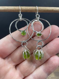 Peridot drop earrings, all set in sterling earrings.  These earrings have the contrast of polished stones in a bezel, with raw stones in a pronged cage.  Peridot is the birthstone for August and the zodiac sign of Leo.  Peridot is known as the stone of compassion. Each piece is a labour of love and comes from my heart.  I aim to create one-of-a-kind works of art, and I strived for this in this piece.   No piece can be replicated, as they each have their own unique characteristics.  I love free f Green Gem Earrings, Bezel Earrings, Love Free, Dope Jewelry, Unique Characteristics, Jewelry Lookbook