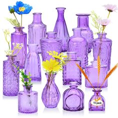 purple glass vases with flowers in them on a white background, set against a white backdrop