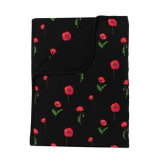 a black blanket with red flowers on it