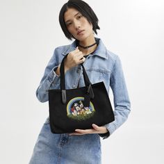 Beloved Disney characters meet iconic Coach design in this special collection starring the one-and-only Mickey Mouse and friends. This playfully practical carryall is crafted of 100 percent recycled canvas made with recycled polyester––even its leather contains at least 50% recycled content. It features Minnie Mouse Mickey Mouse Goofy Pluto Donald Duck and Daisy Duck striking a pose. | Disney X Coach Tote 30 In 100 Percent Recycled Canvas With Mickey Mouse And Friends - Women's - Silver/black Disney Tote, Coach Disney, Rainbow Graphic, Coach Tote Bags, Coach Tote, Daisy Duck, Recycled Canvas, Leather Coach, Mickey Mouse And Friends