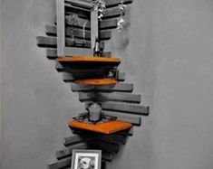 an unusual shelf made out of books in the shape of a spiral staircase with pictures on it