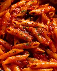 pasta with sauce and parmesan cheese in a bowl on top of a table