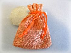 an orange bag sitting next to a white rock