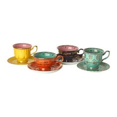 four different colored cups and saucers on a white surface with gold trimmings