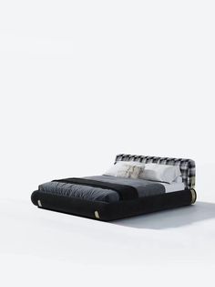 a black and white bed sitting in the middle of a room